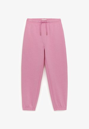 Pantalon de survêtement rose à taille élastique avec cordon réglable et jambes fuselées se terminant par des bords-côtes élastiques.