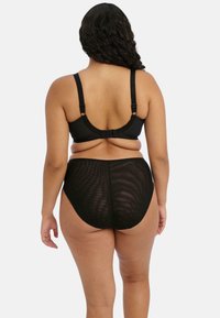 Schwarzes BH- und hochgeschnittenes Slips-Set, mit glatter Textur, verstellbaren Trägern und elastischem Bund. Durchsichtige Einsätze am Slip.