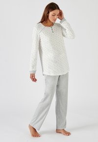 Light gray pajama set with long-sleeve top featuring floral pattern and buttoned neckline, paired with matching gray trousers, cotton material.