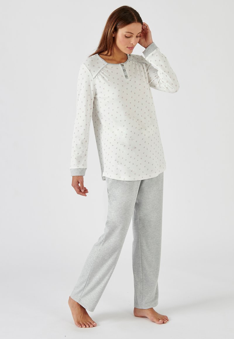 Light gray pajama set with long-sleeve top featuring floral pattern and buttoned neckline, paired with matching gray trousers, cotton material.