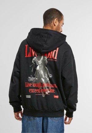 Black hoodie with a large graphic print on the back featuring a rider on a horse, red text, and a barcode at the bottom.