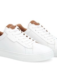 White leather sneakers with round toes, flat rubber soles, and textured brown accents at the heel. Features white laces and stitching details.