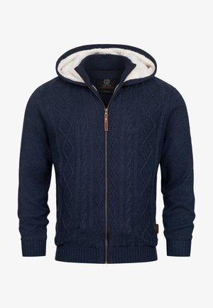Marineblaues, kabelgeknüpftes Zip-Hoodie mit weißem Kunstfellfutter, gerippten Bündchen und Säumen sowie einem Reißverschluss-Anhänger aus braunem Leder.