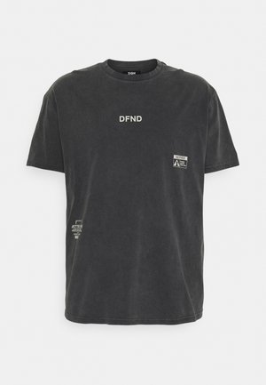 Black short-sleeve T-shirt with white "DFND" text on chest and small printed labels, including a "NOTICE" label on the right side.