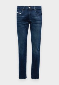 Dark blue denim jeans with a straight leg design, five pockets, and a small red and blue accent on the front pocket.