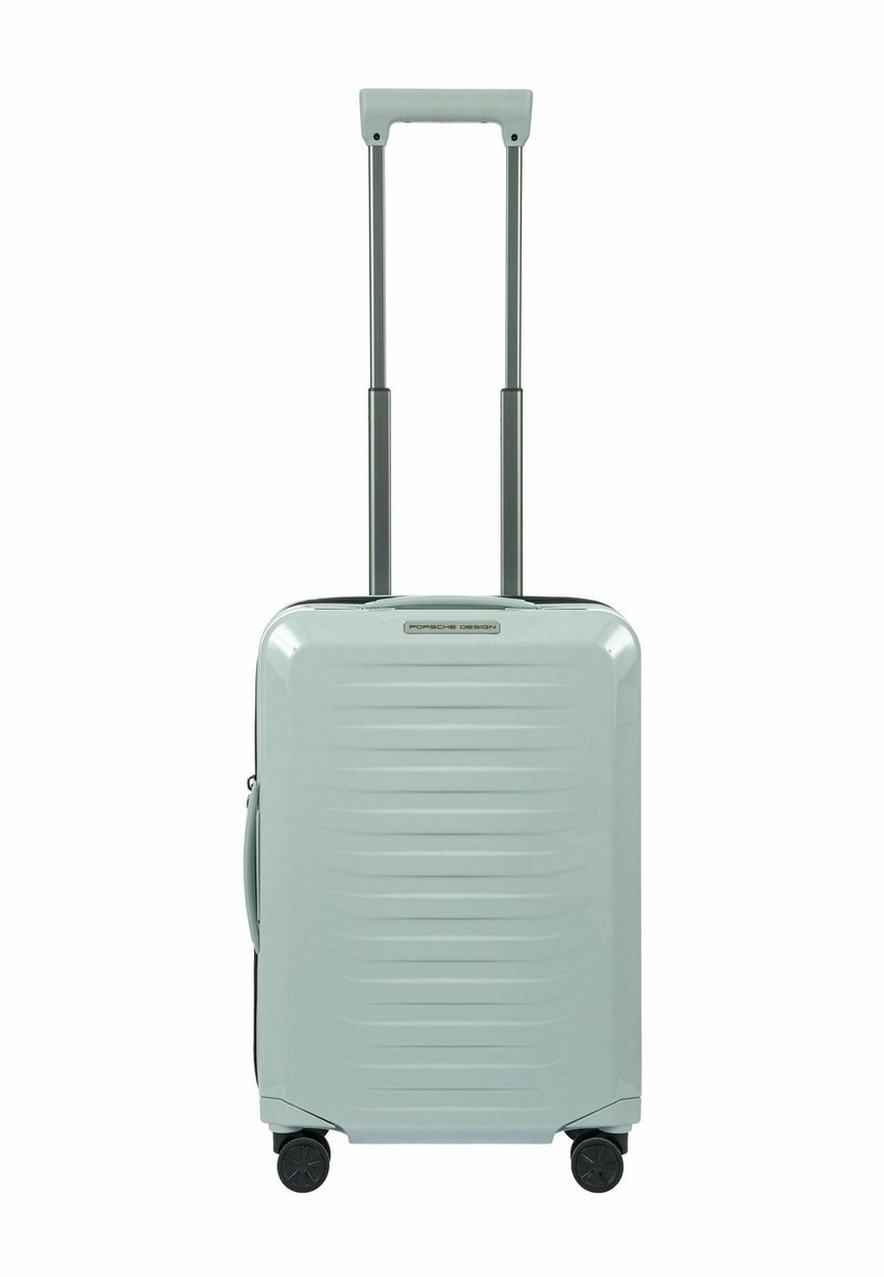 Valigia rigida da cabina di colore blu chiaro con striature orizzontali, manico retrattile e ruote nere per una facile mobilità. Design leggero e durevole.