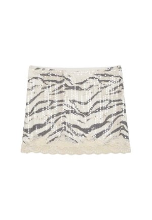 Mini-jupe avec sequins argentés dans un motif à rayures zèbre et une bordure en dentelle le long de l'ourlet, tons crème et gris.