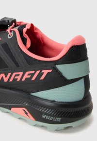 Black athletic shoe with pink accents, including a cushioned inner collar. Features a textured mint green heel and a ridged sole labeled "SPEED LITE."