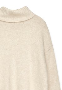 Light beige sweater with a ribbed, high collar. Soft texture, relaxed fit, and dropped shoulder seams. Knitted material with subtle variations.