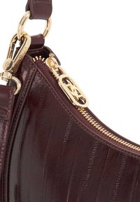 Burgundy leather handbag with vertical striping, gold hardware, and a zipper closure. Features a detachable strap and polished finish.