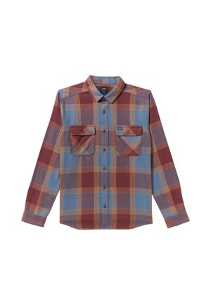 Chemise à carreaux rouge, bleue et jaune. Comprend deux poches poitrine, des manches longues et un col pointu. En coton ou en mélange de matériaux.