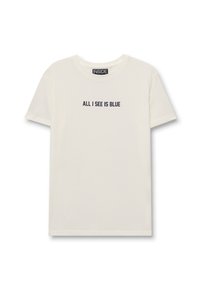 Camiseta de manga corta color crema, hecha de algodón, que presenta un diseño de texto azul "TODO LO QUE VEO ES AZUL" en la parte delantera. Forma clásica de cuello redondo.