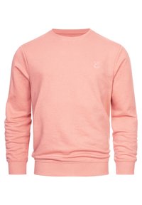Jasnoróżowy sweatshirt z okrągłym dekoltem, ściągaczami przy rękawach i u dołu. Posiada subtelny detal logo na klatce piersiowej. Wykonany z miękkiej bawełny.
