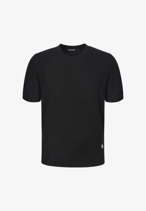 Black short-sleeve crew neck sweater with small white logo on lower left front and ribbed hem and cuffs.