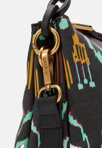 Värikäs nahkalaukku, jossa on elävä abstrakti kuvio, metallinhohtoinen kultainen varuste ja musta hihna, jossa on koristeellinen ommel.
