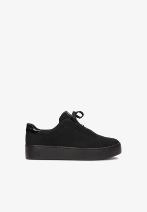 Black canvas sneakers with glossy black patent accents, rounded toe, thick platform sole, and lace-up closure featuring matching shoelaces.