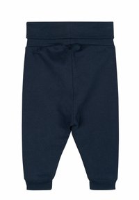 Navyblaue Sweatpants aus Baumwolle mit einem gerippten Taillenbund, schmal zulaufenden Beinen und elastischen Bündchen. Glatte Textur, keine sichtbaren Muster oder Akzente.