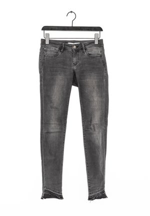 Jeans skinny in denim grigio scuro con finitura slavata, caratterizzati da chiusura con bottoni, due tasche frontali e orli sfrangiati alle caviglie.