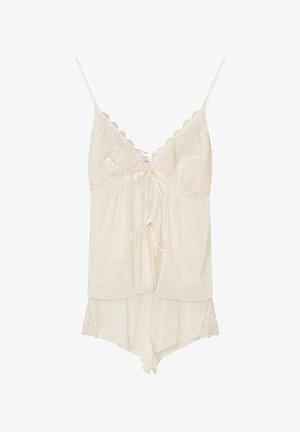 Kremowa koszulka na ramiączkach z koronkowym wykończeniem, z regulowanymi ramiączkami, posiadająca warstwowy krój oraz detal z wiązaniem z przodu.