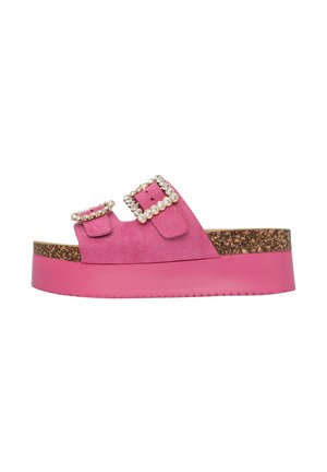 Pink platform sandals made of suede with cork midsole. Features dual straps and square rhinestone buckles for added detail.