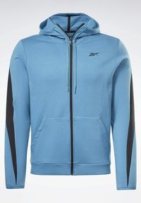 Ljusblå hoodie med en svart sidpanel, har en framficka med dragkedja, justerbar huva med snörning och två framfickor.