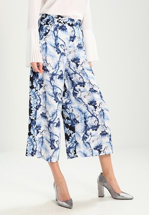 Pantalon ample à jambes larges à motif floral en bleu, blanc et noir avec une taille haute. Confectionné en tissu léger, présentant un motif floral audacieux.