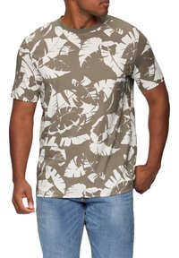 Camiseta de manga corta en algodón verde oliva con estampado de hojas tropicales blancas. Diseño clásico de cuello redondo. Textura suave con corte relajado.