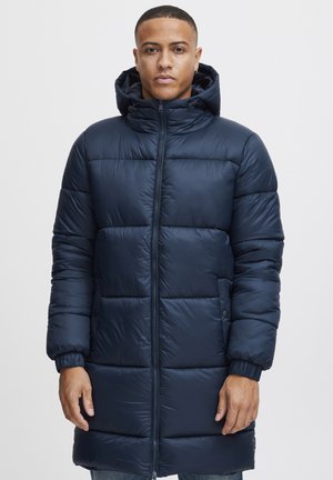 Navy puffer coat with a hood, featuring a zippered front, ribbed cuffs, and horizontal quilted patterns for insulation and style.