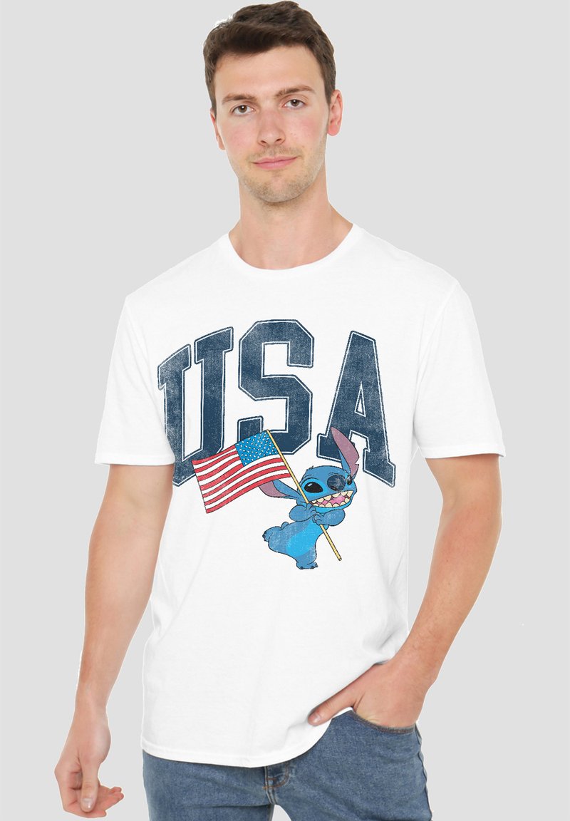 White cotton t-shirt featuring a blue character holding an American flag, with "USA" printed in large blue letters above.