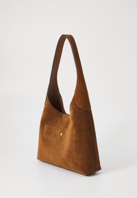 Brown suede shoulder bag with a single strap and a front pocket. The design is sleek, featuring a subtle gold accent.