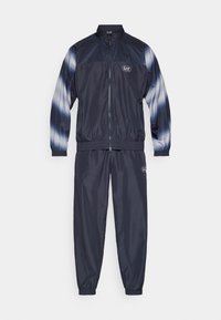 Navy tracksuit featuring a lightweight, glossy fabric. Jacket has a high collar and zip closure; pants have elastic cuffs. Subtle blue accents on sleeves.