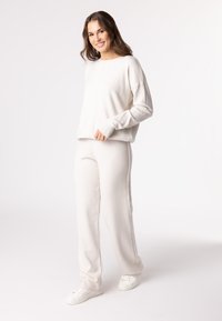 QUIOSQUE Teplákové kalhoty - off-white