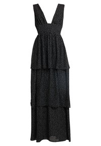 Robe noire avec un décolleté en V profond, des couches superposées et des pois blancs. Fabriquée en tissu léger avec une silhouette fluide.