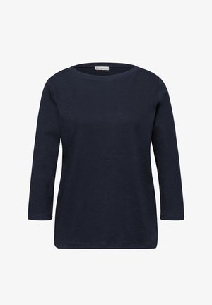 Chemise bleu marine à manches longues avec col rond, ourlet droit et coupe ajustée, présentée sur un fond blanc.