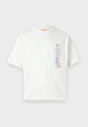 Camiseta corta blanca de manga corta hecha de algodón, con un diseño gráfico gris en el frente y cuello redondo. Ajuste plano y relajado.