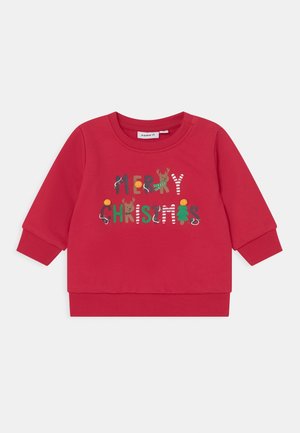 Rød børne-sweatshirt med teksten "Glædelig jul" udsmykket med rensdyr, juletræ, slikstok og festlige lys.