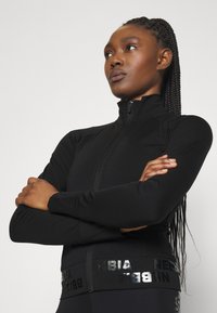 Nebbia NEBBIA WOMEN'S ZIP-UP JACKET INTENSE WARM-UP - Treningsjakke - black