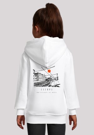 White hoodie featuring a graphic design of a sunset over a train track and buildings, with the text “ESCAPE AND DISCOVER THE WORLD.”