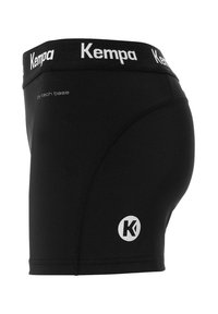 Shorts de compression noirs pour l'athlétisme avec une ceinture et un logo de marque "Kempa" sur la jambe, avec le texte "dry tech base" près de la hanche.