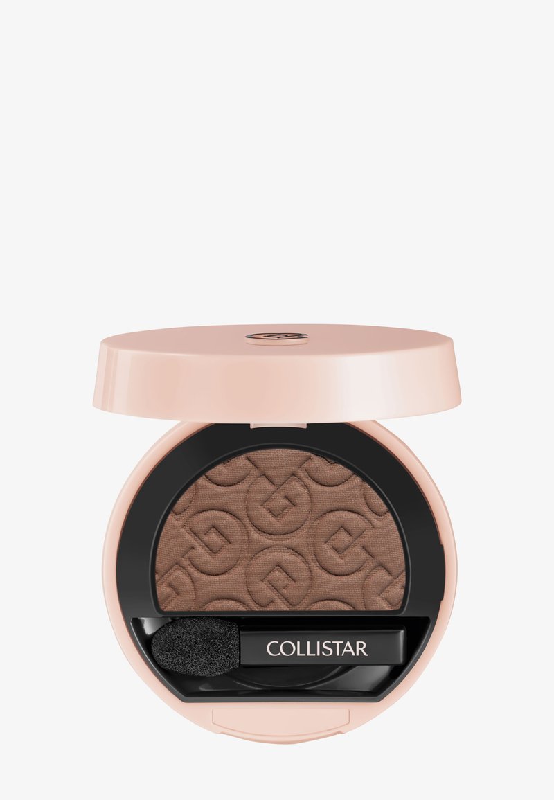 Compact round beige eyeshadow case open to reveal pressed brown eyeshadow with embossed pattern and small black brush labeled "Collistar."