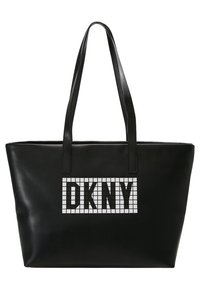 Černá kožená taška přes rameno s dvěma uchy, s velkou bílou mřížkou a písmeny "DKNY" v tučném černém písmu na přední straně.