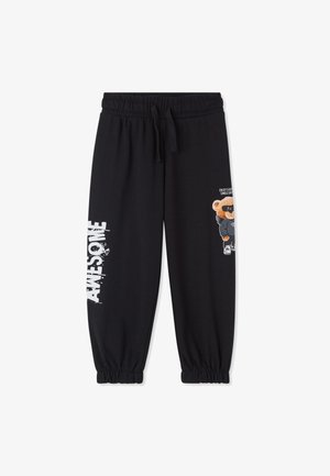 Czarne dresowe spodnie z elastycznym pasem z białym napisem "AWESOME" na lewym nogawce oraz misiem w okularach przeciwsłonecznych i kapturze na prawej nogawce.