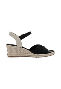 Sandale compensée noire et beige avec semelle en jute tressée, brides croisées à l'avant et bride à la cheville avec fermeture à boucle.