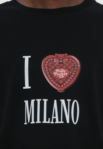 Black t-shirt featuring a red heart-shaped graphic with a bow and "Polly Pocket" text, accompanied by the phrase "I LOVE MILANO" in white letters.