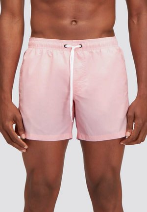 Bañador corto rosa con una cinturilla elástica, cordón blanco y una textura suave y ligera. Presenta un diseño sencillo de color sólido.