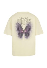 Yellow cotton t-shirt featuring a large purple butterfly graphic on the back, with stylized text above in black, set against a painted background.