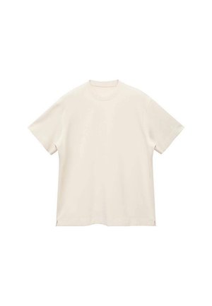 Short-sleeve, crew-neck t-shirt in soft, off-white fabric, featuring a smooth texture and side slits for a relaxed fit.