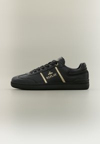Black textured sneakers with gold accents, featuring the "REPLAY" logo, flat laces, and a black rubber sole. Side view.
