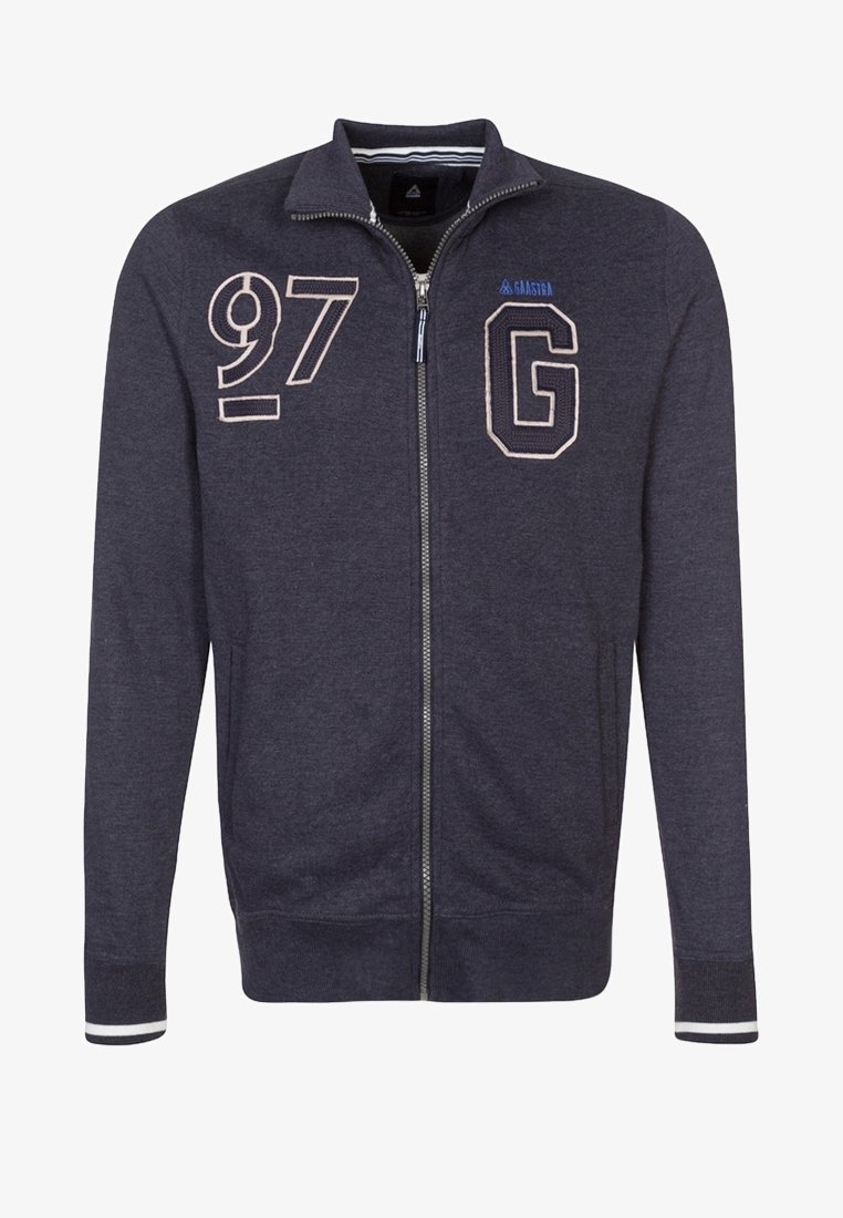 Sweat-shirt à fermeture éclair bleu marine avec "97" et un grand "G" brodés sur la poitrine, poignets côtelés avec bande blanche, et poches latérales.