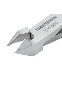 Stainless steel Tweezerman nail nipper with precise angled cutting blades in a close-up view.